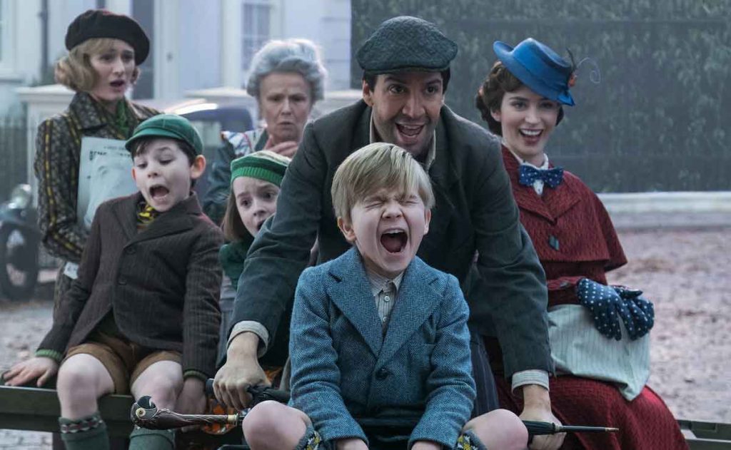 Cast of Mary Poppins returns frolicking on a bike.