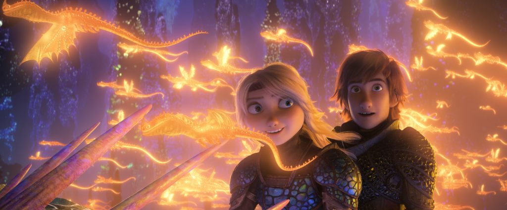 Hiccup and Astrid riding a dragon among glowing dragons